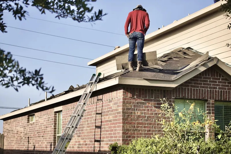 Professional roofer working on a residential roof in The Pinery